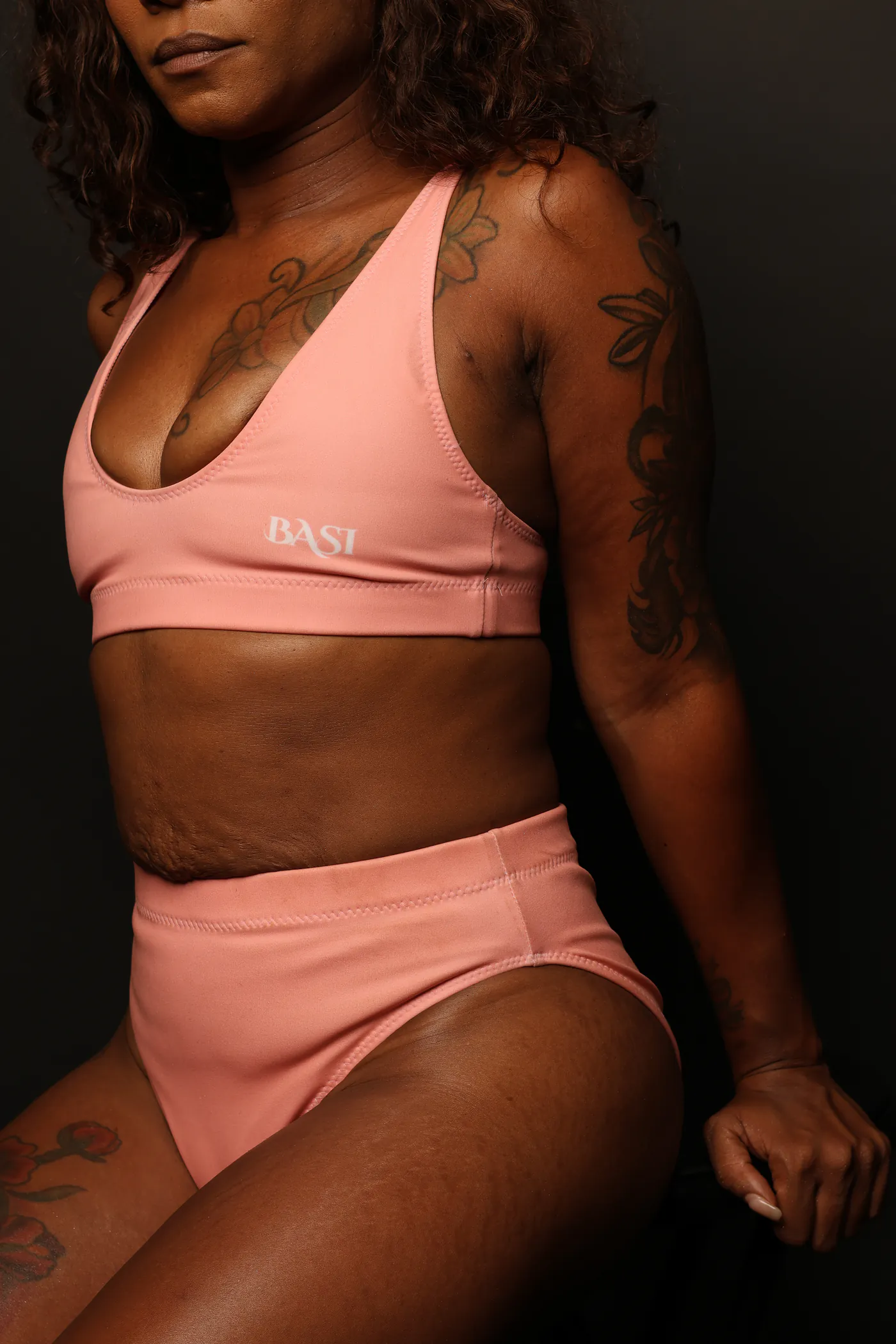 Model wearing a cotton-candy high-waisted Swim BASI bikini in a studio